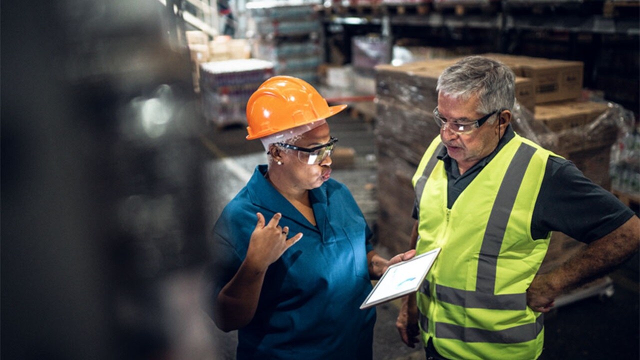 Two co-workers in a warehouse.