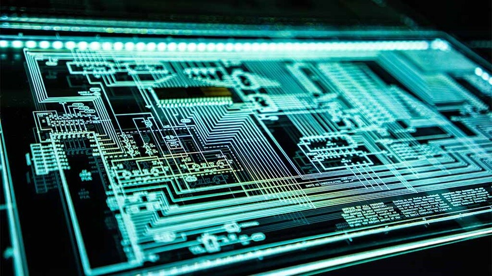 Close-up of a teal LED panel with glowing lights and circuitry
