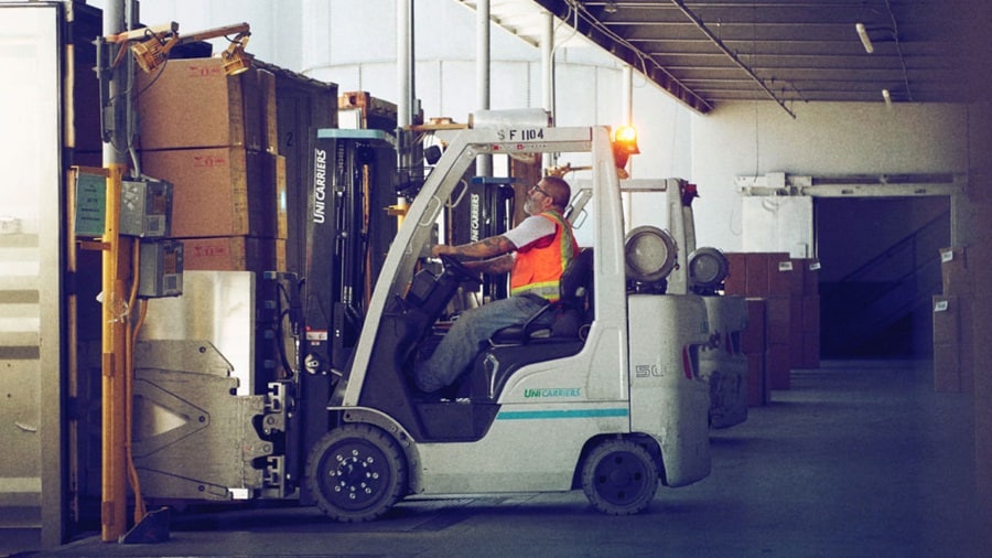 Person carrying load in warehouse