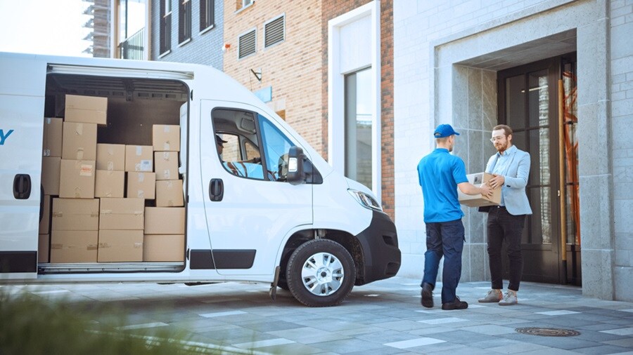 Man handing the courier to another man