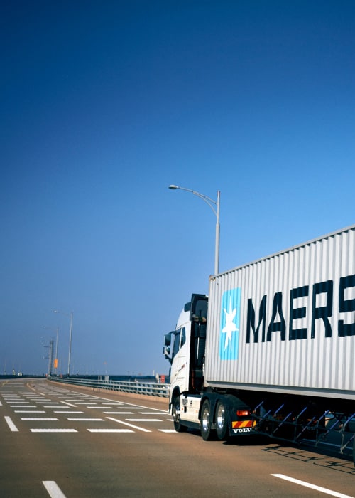 Image of a truck with a Maersk premium quality container with an extra layer of protection for safeguarding goods.